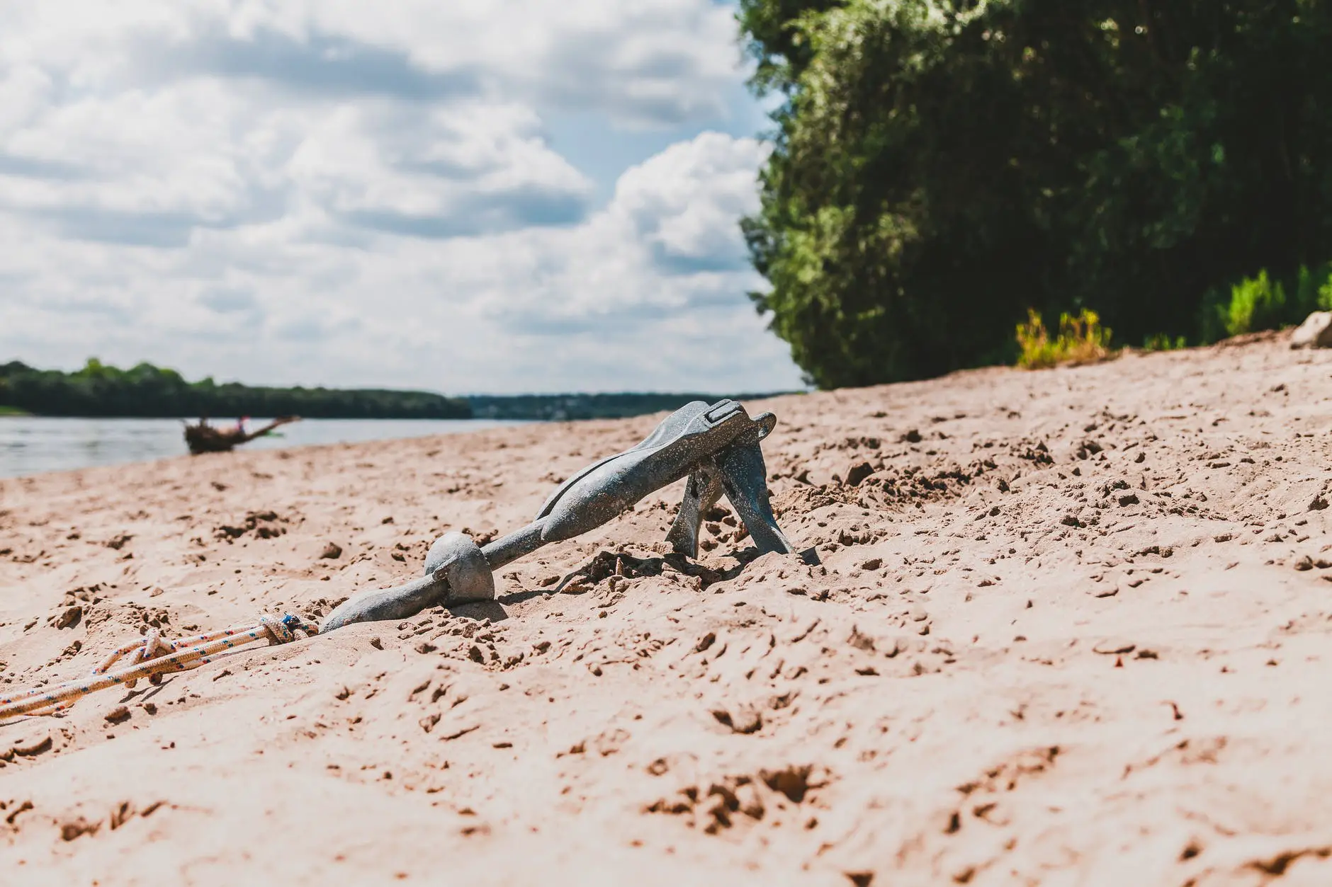gray sand anchor near seashore