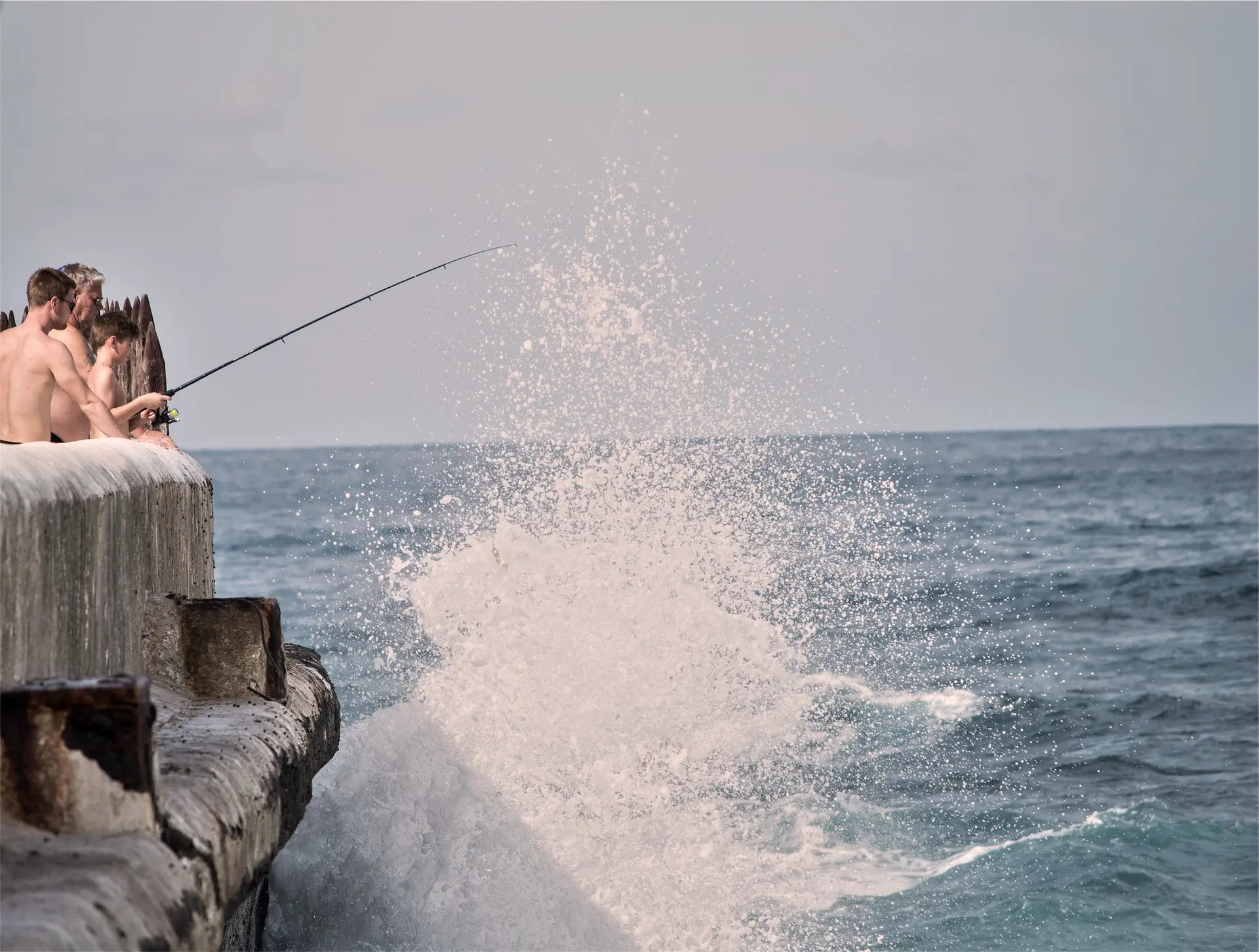 Fishing from a seawall in rough conditions