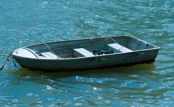 A row boat anchored offshore