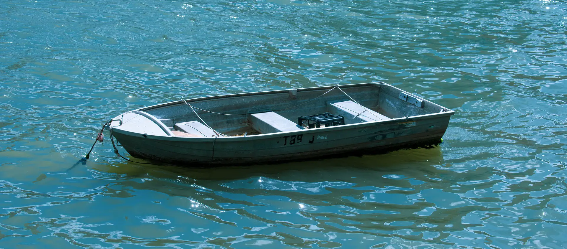 A row boat anchored offshore